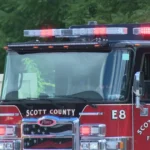 A Scott County fire engine on a highway shoulder after a fatal crash on I-75