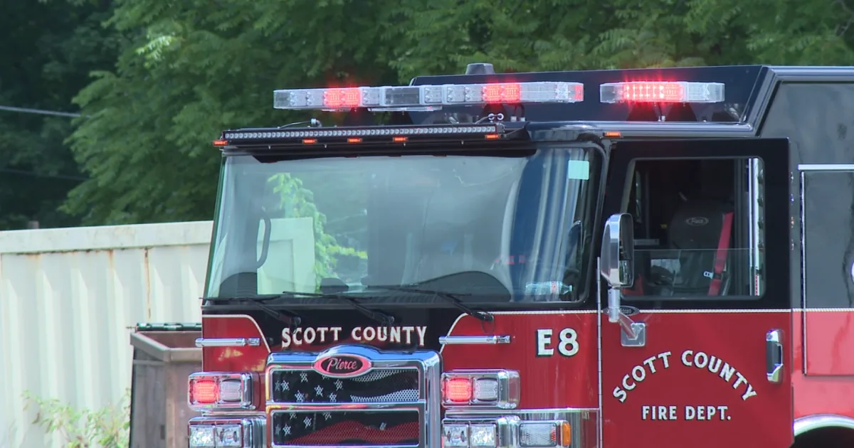 A Scott County fire engine on a highway shoulder after a fatal crash on I-75
